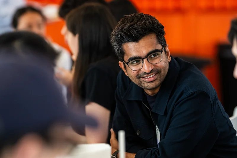 A candid conversation at a table during a Y Combinator (YC) gathering, from Govind Kavaturi’s Dock archive.
