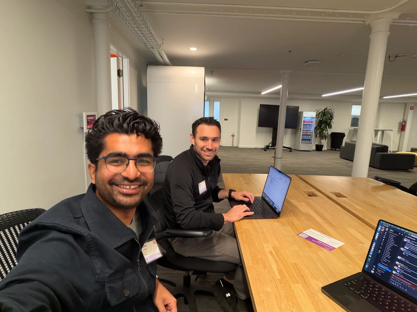 Govind Kavaturi and Mike Molinet working on laptops at a shared table, from Dock’s Y Combinator (YC) S26 archive.