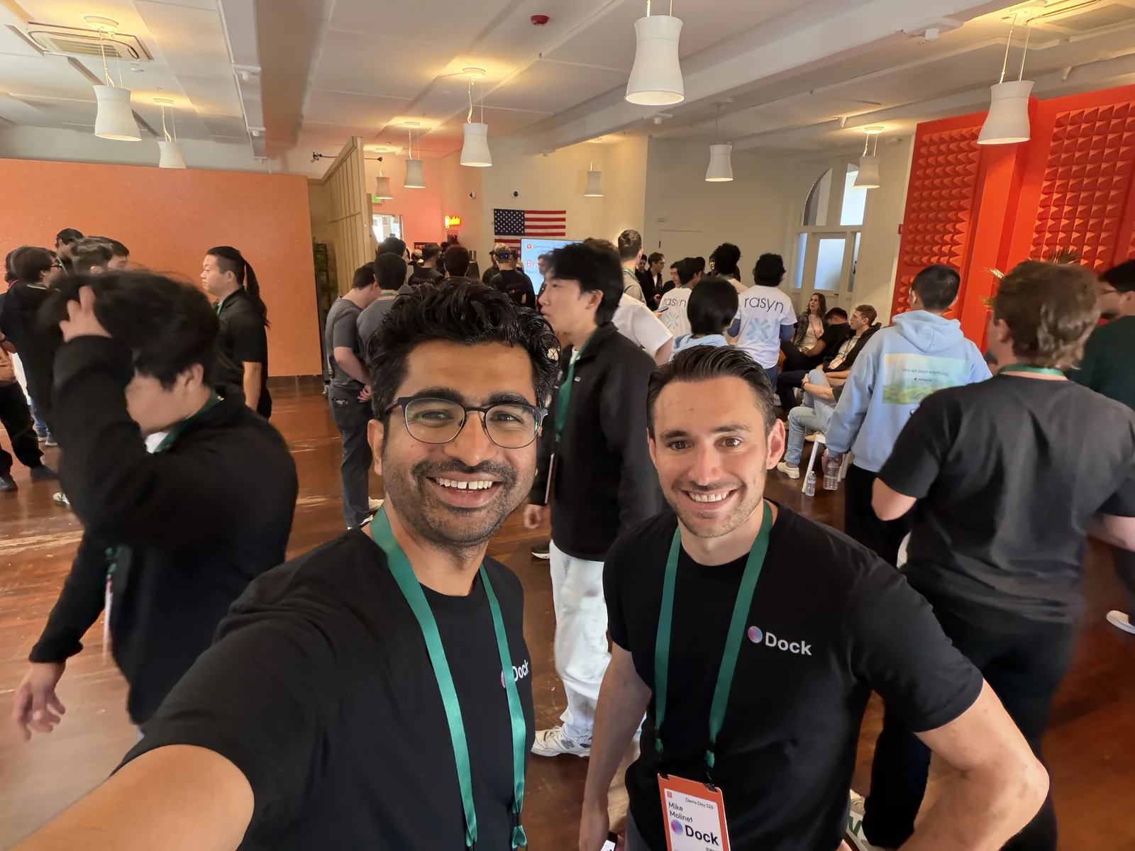 Govind Kavaturi and Mike Molinet taking a selfie in Dock shirts and event lanyards at a Y Combinator (YC) gathering.